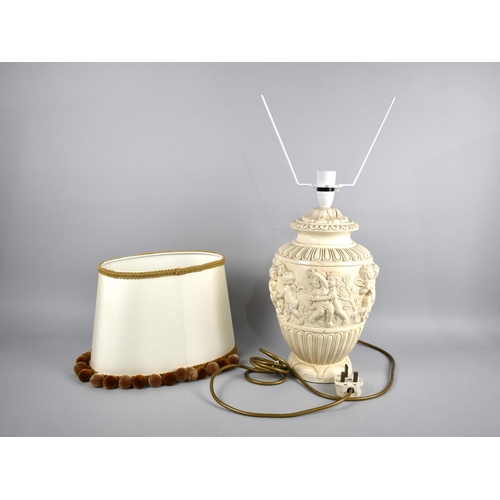 228 - A Continental Relief Decorated Table Lamp, With Shade