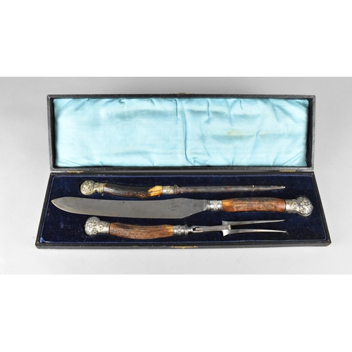 4 - A Late Victorian/Edwardian Cased Three Piece Carving Set with Silver Plated Mounts and Horn Handles