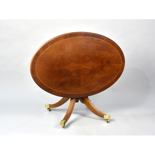 93 - A Late 20th Century Crossbanded Mahogany Oval Top Snap Top Coffee Table with Brass Claw Castors, 88c... 