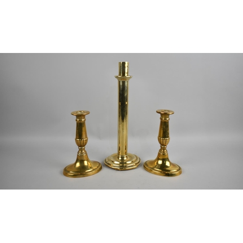 113 - A Single 19th Century Heavy Brass Candlestick, 28cms High, together with a Pair of Brass Candlestick... 