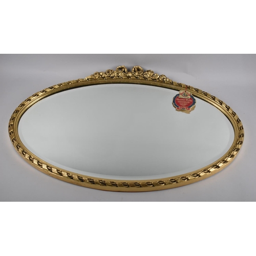 157 - A Mid 20th Century Gilt Framed Oval Wall Mirror with Bevelled Glass, 72x48cms