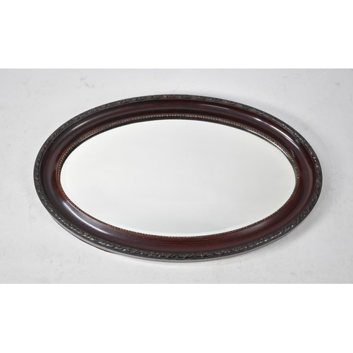 197 - An Edwardian Oval Wall Mirror, 80cms Wide