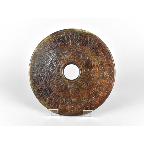 241 - A Chinese Hardstone Archaistic Bi Disc, 19.5cm Diameter