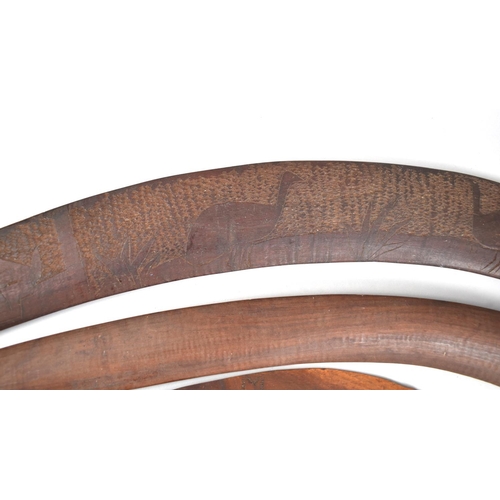 134 - A Set of Three Aboriginal Souvenir Boomerangs with Carved Decoration Depicting Game