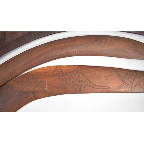 134 - A Set of Three Aboriginal Souvenir Boomerangs with Carved Decoration Depicting Game