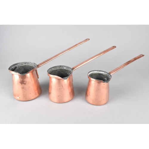 137 - A Set of Three Graduated Copper Cider Warmers