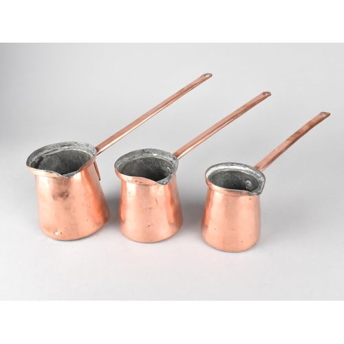 137 - A Set of Three Graduated Copper Cider Warmers