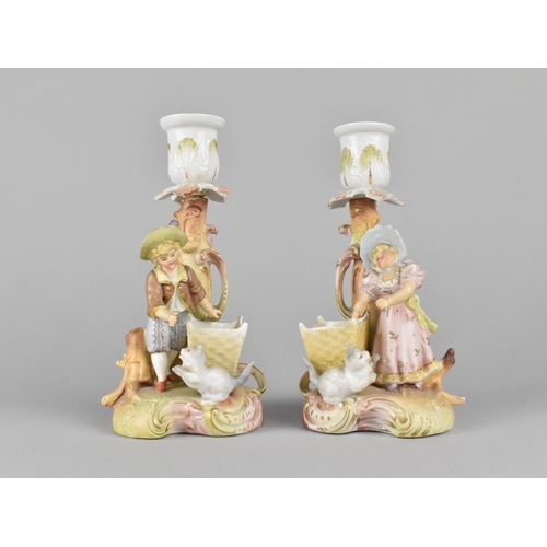 406 - A Pair of Continental Cold Painted Bisque Candlesticks decorated with Figures and Cats together with... 