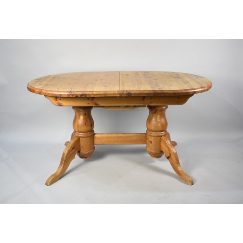 572 - An Extending Oval Pine Dining Table, 189cms by 91cms