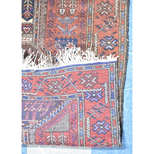 597 - An Antique Persian Patterned Rug, 140x88cms