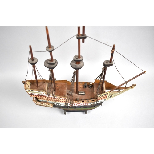 63 - A Sailor's Handmade and Painted Wooden Model of a Four Masted Tall Ship, 33cms Long