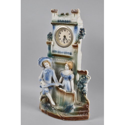 67 - A Continental Painted Bisque Mantel Clock in The Form of Tower with Figures at Base, 32cms High