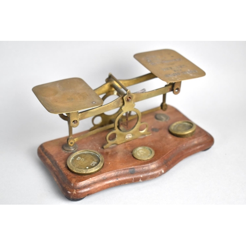 78 - A Set of Edwardian Brass Postage Scales with Weights, Mahogany Serpentine Plinth, 17cms Wide