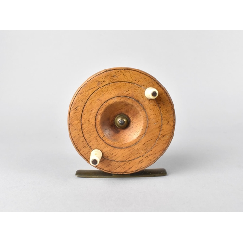 A Vintage Brass Mounted Wooden Fly Fishing Reel, 7.75cms Diameter