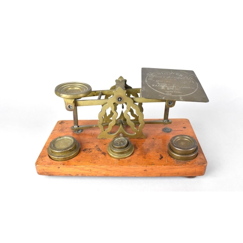 85 - An Edwardian Set of Brass Postage Scales with Weights on Rectangular Wooden Plinth Base, 21cms Wide