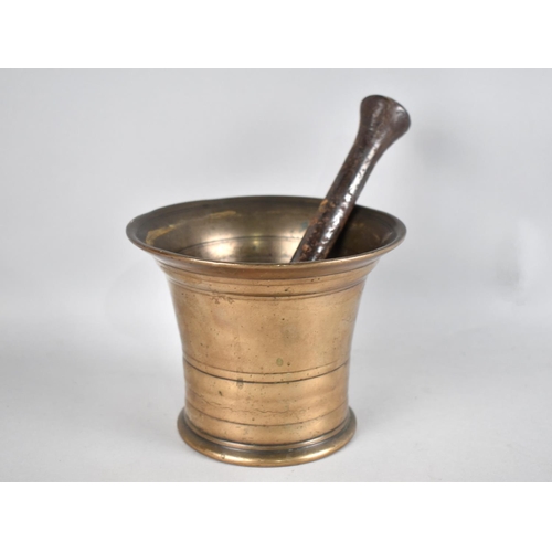 86 - A 19th Century Polished Bronze Mortar together with an Earlier Iron Pestle, 14cms Diameter