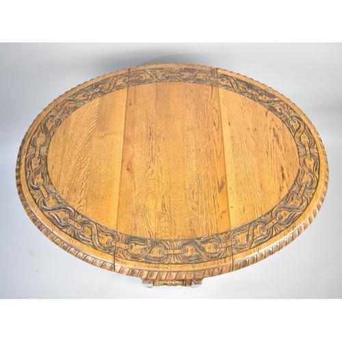 154 - A Mid 20th Century Oak Drop Leaf Oval Topped Gate Leg Table with Carved Border, 61cms Wide