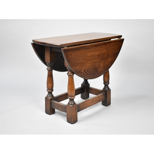 183 - A Small Mid 20th Century Oak Oval Topped Drop Leaf Occasional Table, 56cms Long