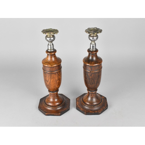 26 - A Pair of Oak and Silver Plated Vase Shaped Candlesticks on Octagonal Bases, 30.5cms High