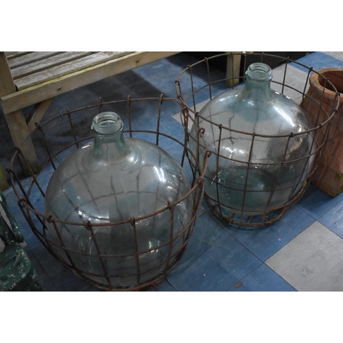 468 - Two Large Glass Demijohns in Wire Surrounds, 51cm high