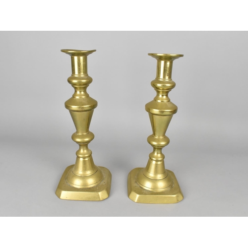 76 - A Pair of Late 19th Century Brass Candlesticks with Pushers, 25cms High