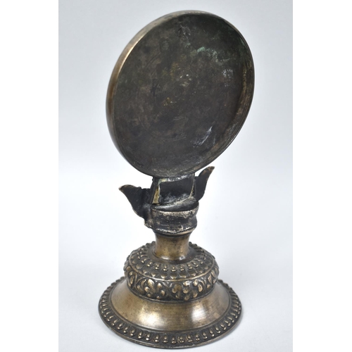 38 - A Mid 19th Century Nepalese Bronze Temple Mirror decorated with Ganesh, Turned Socle, 21cms High