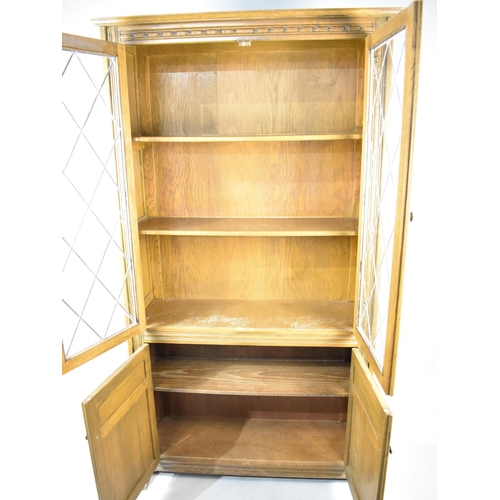 532 - A Mid 20th Century Oak Linen Fold Lead Glazed Bookcase with Cupboard Base, 101cm wide