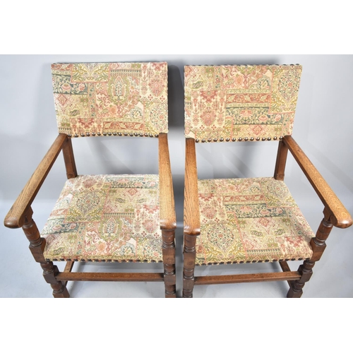 561 - A Pair of Tapestry Upholstered Oak Framed Scroll Armchairs with Brass Studding