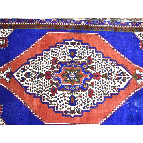 562 - A Patterned Rug on Blue Ground, 185x124cm