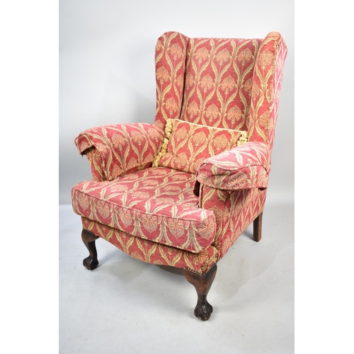 572 - A Modern Upholstered Wing Armchair with Mahogany Claw and Ball Feet