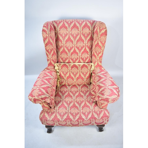 572 - A Modern Upholstered Wing Armchair with Mahogany Claw and Ball Feet