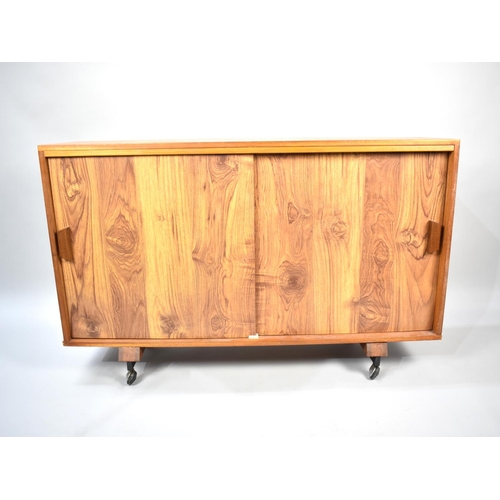 575 - A 1970's Side Cabinet on Casters with Sliding Doors, 120cm wide