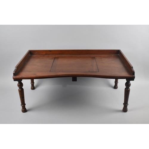 69 - An Edwardian Mahogany Bed Table with Galleried Top and Hinged Centre Bookrest, Turned Supports, 61cm... 