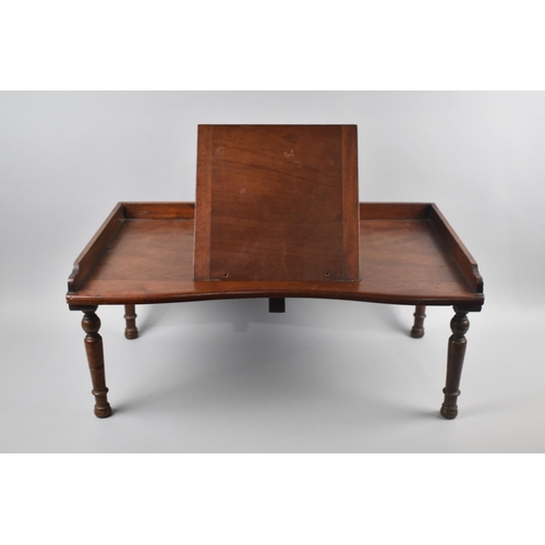 69 - An Edwardian Mahogany Bed Table with Galleried Top and Hinged Centre Bookrest, Turned Supports, 61cm... 