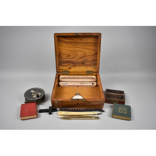 77 - An Olive Wood Box Containing Curios to include Fly Fishing Reel, Gilt Decorated Box, Ebonized Crucif... 