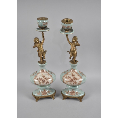 115 - A Pair of Bronze and Porcelain French Style Figural Candlesticks, Holder Supported by Cherubs, 36cms... 