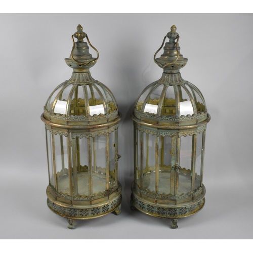 123 - A Pair of Green Patinated Brass Circular Lanterns with pierced Base and Four Claw Feet, 62cms High