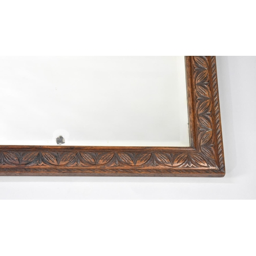 477 - A Mid 20th Century Carved Oak Framed Wall Mirror, 105cms by 50cms