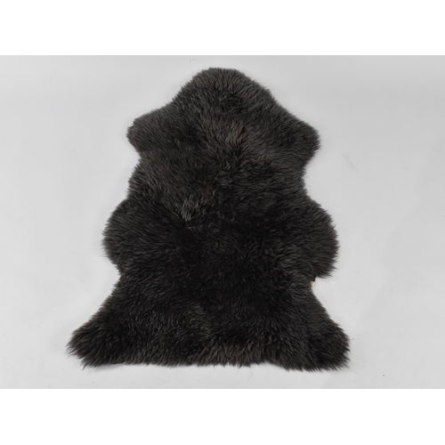 492 - A Black Sheepskin Rug, Approx 97x60cm