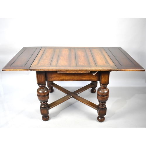 522 - An Edwardian Oak Drawer Leaf Dining Table with Bulbous Supports