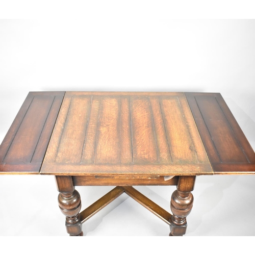 522 - An Edwardian Oak Drawer Leaf Dining Table with Bulbous Supports