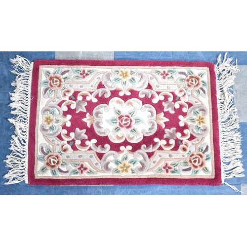 530 - A Small Hearth Rug on Red Ground,91x61cms