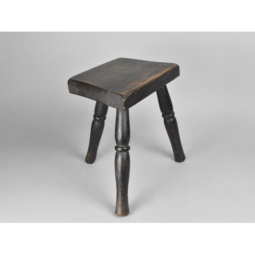 76 - A Rustic Style Three Legged Milking Stool on Turned Supports, 26cms Wide