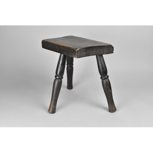 76 - A Rustic Style Three Legged Milking Stool on Turned Supports, 26cms Wide