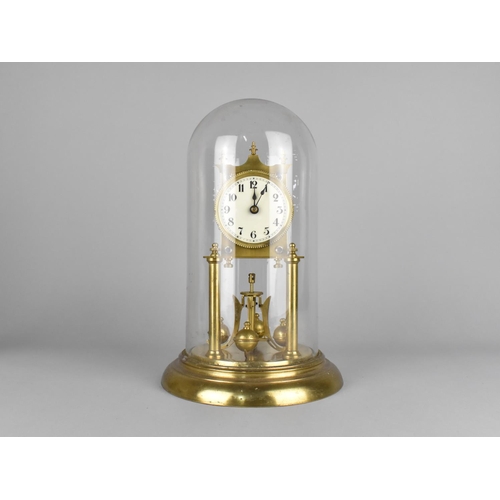 82 - A Mid 20th century Brass Pillar Clock Under Glass Dome, Requires New Suspension, 31cms High