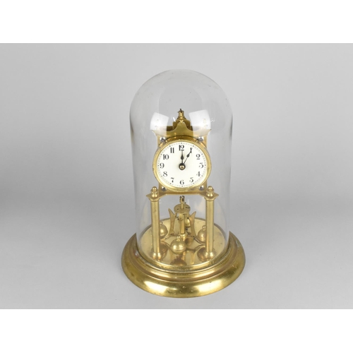 82 - A Mid 20th century Brass Pillar Clock Under Glass Dome, Requires New Suspension, 31cms High