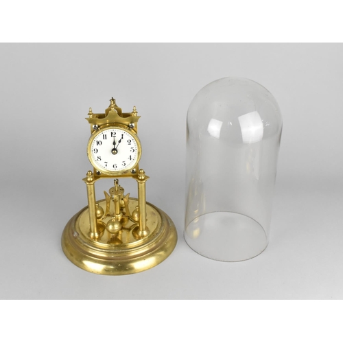 82 - A Mid 20th century Brass Pillar Clock Under Glass Dome, Requires New Suspension, 31cms High