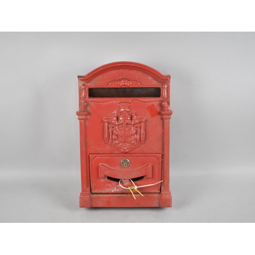 199 - A Red Painted Cast Metal Wall Hanging Post Box, 39cms High, With Keys