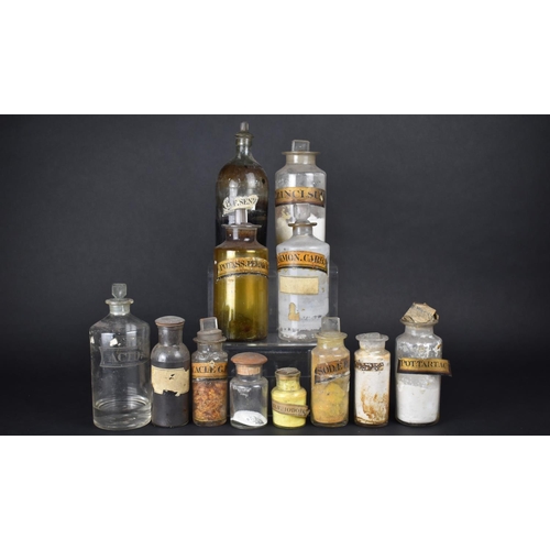A Collection of Twelve Various 19th and Early 20th Century Glass Chemist's or Apothecary Bottles with Paper Labels and One with Etched Label, Tallest 22cm and Smallest 8cm high