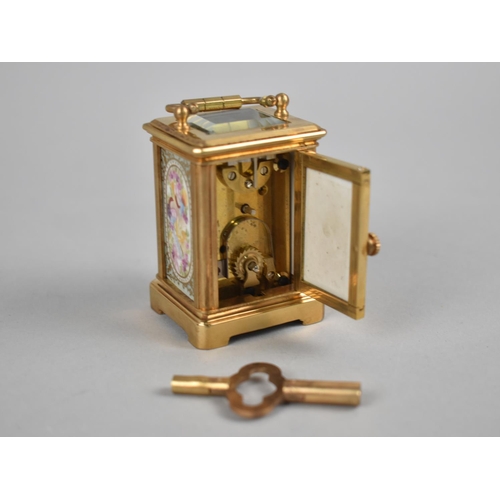 37 - A Reproduction Miniature Gilt Brass and Sevres Style Porcelain Panel Carriage Clock, With Key and Wo... 